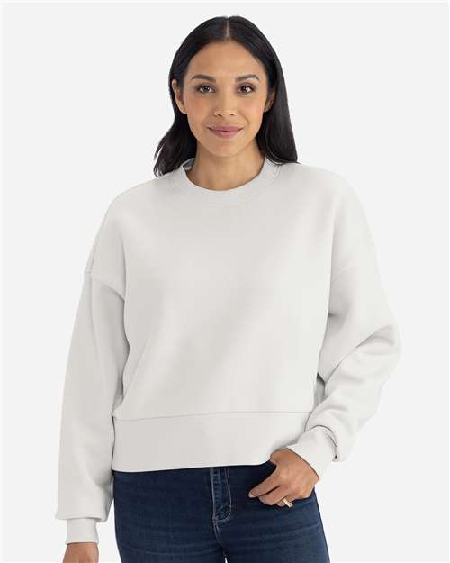Bone - Next Level 9087 Women's Sweatshirt with Logo Embroidery Next Level Women's Heavyweight Crewneck Sweatshirt in Bone, front view on model
