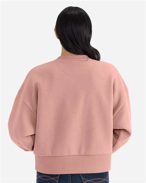 Desert Pink - Next Level 9087 Women's Sweatshirt with Logo Embroidery Next Level Women's Heavyweight Crewneck Sweatshirt in Desert Pink, back view on model