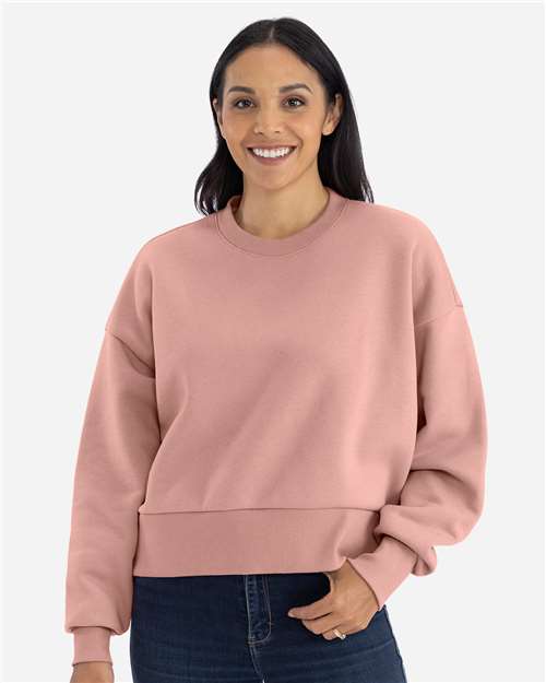 Desert Pink - Next Level 9087 Women's Sweatshirt with Logo Embroidery Next Level Women's Heavyweight Crewneck Sweatshirt in Desert Pink, front view on model