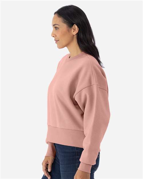 Desert Pink - Next Level 9087 Women's Sweatshirt with Logo Embroidery Next Level Women's Heavyweight Crewneck Sweatshirt in Desert Pink, side view on model