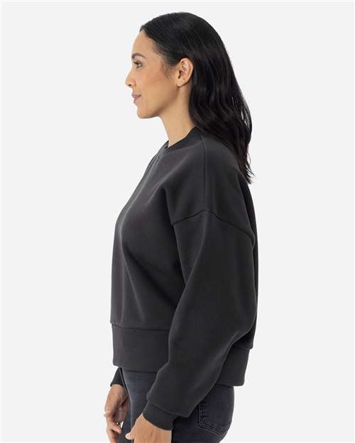 Graphite Black - Next Level 9087 Women's Sweatshirt with Logo Embroidery Next Level Women's Heavyweight Crewneck Sweatshirt in Graphite Black, side view on model
