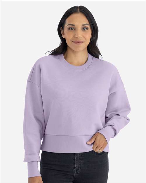 Lavender - Next Level 9087 Women's Sweatshirt with Logo Embroidery Next Level Women's Heavyweight Crewneck Sweatshirt in Lavender, front view on model
