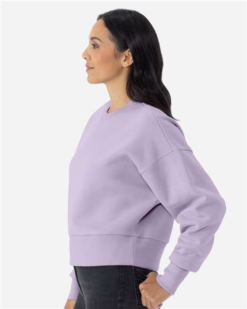 Lavender - Next Level 9087 Women's Sweatshirt with Logo Embroidery Next Level Women's Heavyweight Crewneck Sweatshirt in Lavender, side view on model