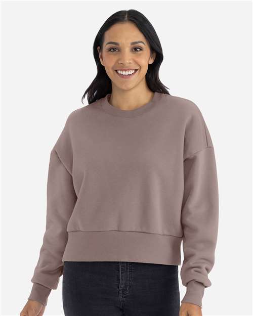 Shiitake - Next Level 9087 Women's Sweatshirt with Logo Embroidery Next Level Women's Heavyweight Crewneck Sweatshirt in Shiitake, front view on model
