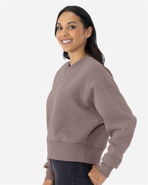 Shiitake - Next Level 9087 Women's Sweatshirt with Logo Embroidery Next Level Women's Heavyweight Crewneck Sweatshirt in Shiitake, side view on model