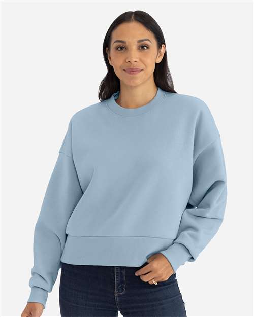 Stonewash Denim - Next Level 9087 Women's Sweatshirt with Logo Embroidery Next Level Women's Heavyweight Crewneck Sweatshirt in Stonewash Denim, front view on model