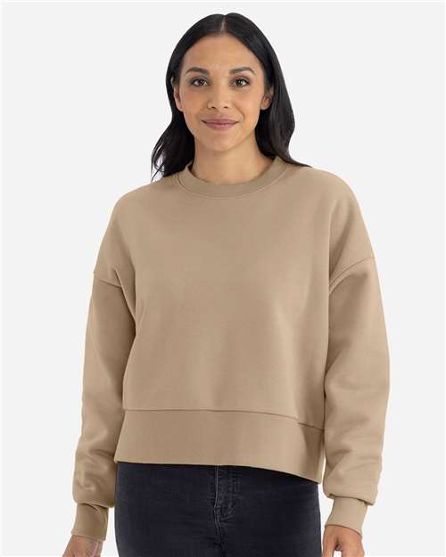 Tan - Next Level 9087 Women's Sweatshirt with Logo Embroidery Next Level Women's Heavyweight Crewneck Sweatshirt in Tan, front view on model