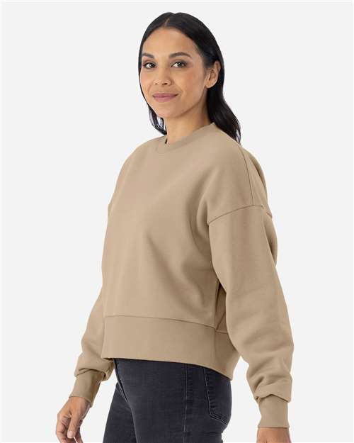 Tan - Next Level 9087 Women's Sweatshirt with Logo Embroidery Next Level Women's Heavyweight Crewneck Sweatshirt in Tan, side view on model