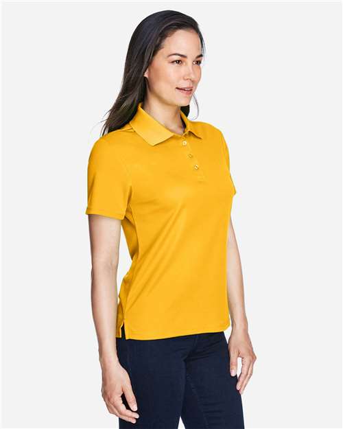 Campus Gold - CORE365 78181 Women's Polo with Embroidered Company Logo CORE365 Women’s Polo in Campus Gold, side view on model