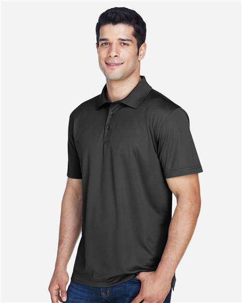 Black - Harriton M315 Men's Polo with Embroidered Company Logo Harriton Men's Polyester Jersey Polo in Black, side view on model