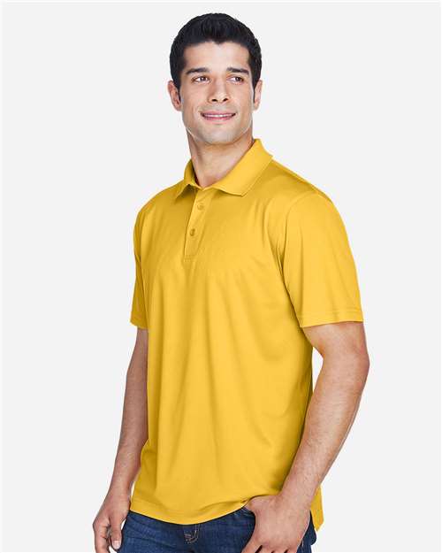 Gold - Harriton M315 Men's Polo with Embroidered Company Logo Harriton Men's Polyester Jersey Polo in Gold, side view on model