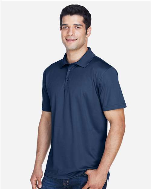 Navy - Harriton M315 Men's Polo with Embroidered Company Logo Harriton Men's Polyester Jersey Polo in Navy, side view on model