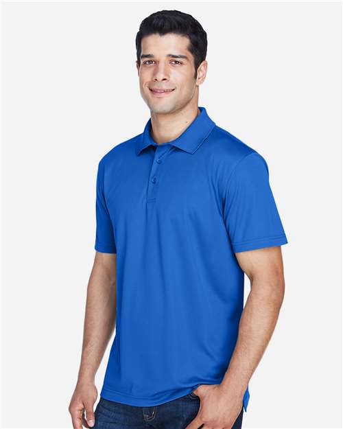 True Royal - Harriton M315 Men's Polo with Embroidered Company Logo Harriton Men's Polyester Jersey Polo in True Royal, side view on model