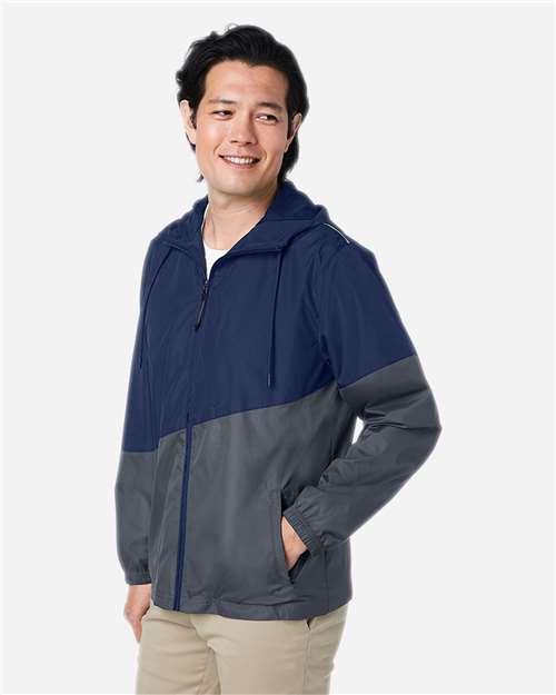 Classic Navy Heather/ Carbon - CORE365 CE710 Windbreaker Jacket with Custom Logo Embroidery CORE365 Unisex Techno Lite Colorblock Windbreaker in Classic Navy Heather/Carbon, side view on model